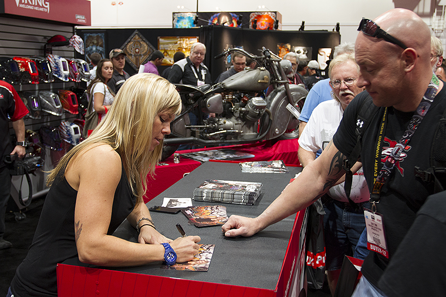 Jessi Combs signing autographs and conversing with her viewers in the Lincoln Electric booth at SEMA